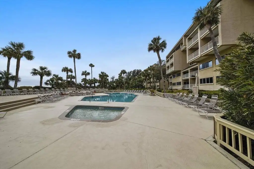 A pool surrounded by palm trees that is A Florida home, that is a Vacation Rentals